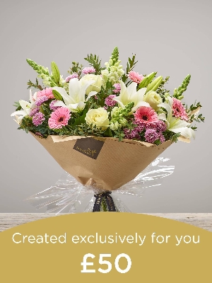 Hand tied bouquet made with seasonal flowers